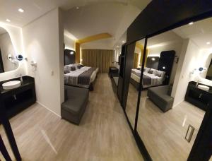 a hotel room with two beds and a mirror at Taua Hotel e Convention Alexania in Alexânia