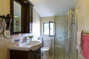 a bathroom with a toilet and a sink and a shower at Judith's Place - Stylish Apartments in Ramat Gan