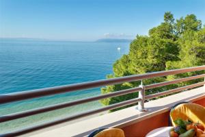 a balcony with a view of the water at Promenada - Beachfront Apartments in Tučepi