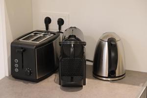 a kitchen counter with a toaster and a tea kettle at Boutique Apartments Freiburg - Eva in Freiburg im Breisgau
