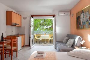 a living room with a couch and a table at Promenada - Beachfront Apartments in Tučepi