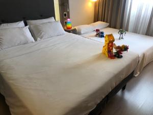 two beds with stuffed animals sitting on top of them at Novotel São Paulo Berrini in São Paulo