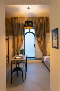 a room with a table and a bed and a window at Bellamania B&B in Anacapri