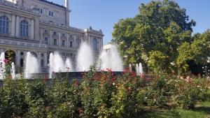 a water fountain in front of a building at APARTMENT IN DERIBASOVSKAY STREET 20 in Odesa