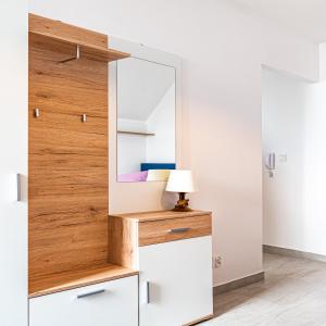 a dressing room with a mirror and a dresser at Velo Apartamenty in Czorsztyn