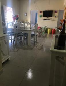 a dining room with a white table and chairs at Vista pro mar maravilhosa,Tibau-RN in Tibau