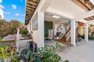 an open porch of a home with stairs and plants at Heaven Can't Wait in Stuart