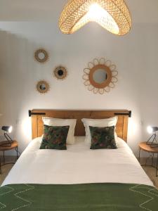 a bedroom with a bed and a chandelier at Mazet LEAJO in Eygalières +17 photos