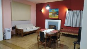 a living room with a couch and a table at GLAMAUÉ in Carhué