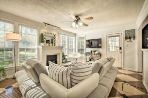 a living room with a couch and a fireplace at Brenham Bungalow with Yard, 1 Mi to Downtown! in Brenham