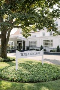 a sign in the grass in front of a building at The Inn at Longshore in Westport