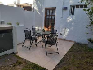 a table and chairs sitting on a patio at Duplex Valeria del Mar in Valeria del Mar