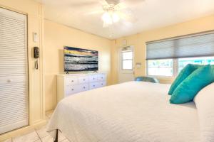 1 dormitorio con 1 cama y ventilador de techo en Tropic Terrace #22 - Beachfront Rental condo, en St Pete Beach
