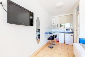 
a kitchen with a refrigerator, microwave, sink, and dishwasher at Motel Ingham in Ingham
