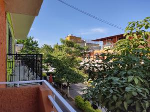 a balcony with a view of a street and trees at Hostal Herencia in Tequila