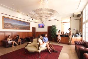 a group of people sitting in a waiting room at Astor Metropole Hotel in Brisbane