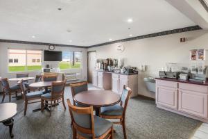 a kitchen and dining room with tables and chairs at Americas Best Value Inn-Wenona in Wenona