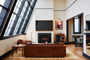 a living room with a couch and a fireplace at Shinola Hotel in Detroit