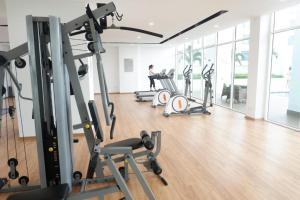 a gym with treadmills and machines in a room at GYDEN STAYCATION #Pinnacle Tower at JB City Centre in Johor Bahru