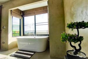 a bathroom with a large tub and a window at Lounge in Loft HuaHin Pool Villa บ้านพักในหัวหิน in Ban Wang Bot +24 photos