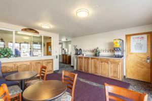 a restaurant with tables and chairs and a counter at Americas Best Value Inn Burns in Burns