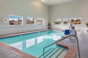 a swimming pool with blue water in a building at Americas Best Value Inn Burns in Burns
