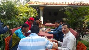 a group of people sitting around a table eating at Hotel Middle Path & Spa in Pokhara