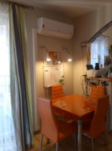 a dining room with a table and orange chairs at Chata Mego Brata in Limanowa