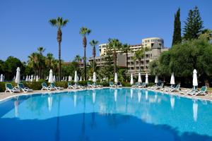 a large swimming pool with lounge chairs and umbrellas at Barut Hemera - Ultra All Inclusive in Side