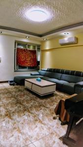 a living room with a couch and a table at Home is Love house Homestay in Chaozhou