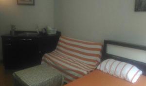 a bedroom with a bed and a dresser and a bench at Room in Condo - Impact Thunder Dome Service Taxi in Thung Si Kan