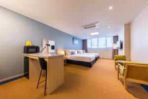 a large hotel room with a bed and a desk at Days Hotel & Suites by Wyndham Incheon Airport in Incheon