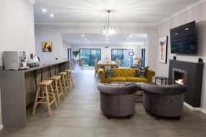 a living room with a yellow couch and a fireplace at Melville Gap Guesthouse in Johannesburg