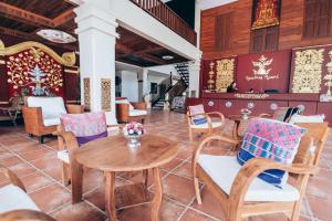 a dining room with a table and chairs at Sasidara Resort Nan in Nan