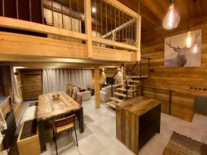 a living room with wooden walls and a staircase at chalet la grange in Tignes