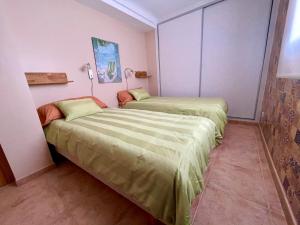 a room with two beds in a room at Royal Beach House Vista Mar in La Mata