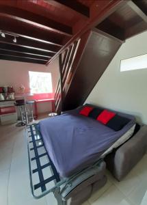 a large bed in a room with a attic at La Kaz d'Évania in Sainte-Rose