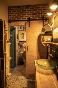 a bathroom with a green sink and a mirror at Le Refuge Cérétan, grand et bel appartement mansardé en plein centre in Céret +20 photos