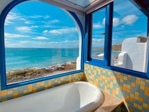 La salle de bains est pourvue d'une baignoire et offre une vue sur l'océan. dans l'établissement Seyan Inn, à Eluan