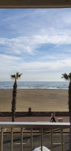 a view of the beach from a balcony at Studio les pied dans l eau ! in Canet-en-Roussillon