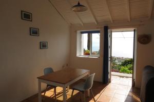 a dining room with a table and chairs and a window at Vistas del Sur in Alajeró