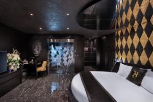a bedroom with a bed and a table and a chair at H Hotel & SPA - Adults Only in St. Julianʼs