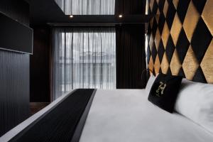 a bedroom with a white bed with a large window at H Hotel & SPA - Adults Only in St. Julianʼs