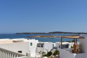 a view of the ocean from a white building at Angels Pillow Luxury Boutique Residence - Adults Only in Naousa