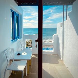 a balcony with a view of the ocean at Seyan Inn in Eluan