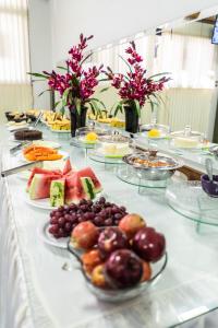 a buffet with plates of food on a table at Pousada Paraiso in Guanambi