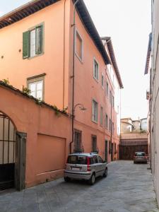 a car parked in a parking lot between two buildings at Residence il Duomo in Lucca