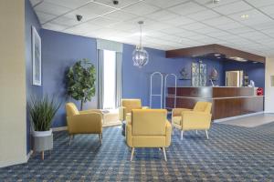 a waiting room with yellow chairs and a waiting area at Seaport Resort and Marina in Fairhaven