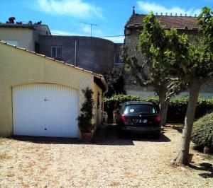 a car parked in the driveway of a house at Maison des clairettes entre Camargue, Arles & Nîmes in Bellegarde