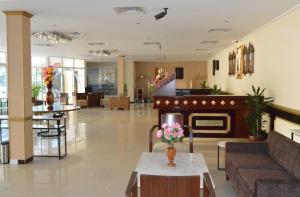 a lobby of a hospital with flowers on a table at Ramee Dream Resort in Seeb